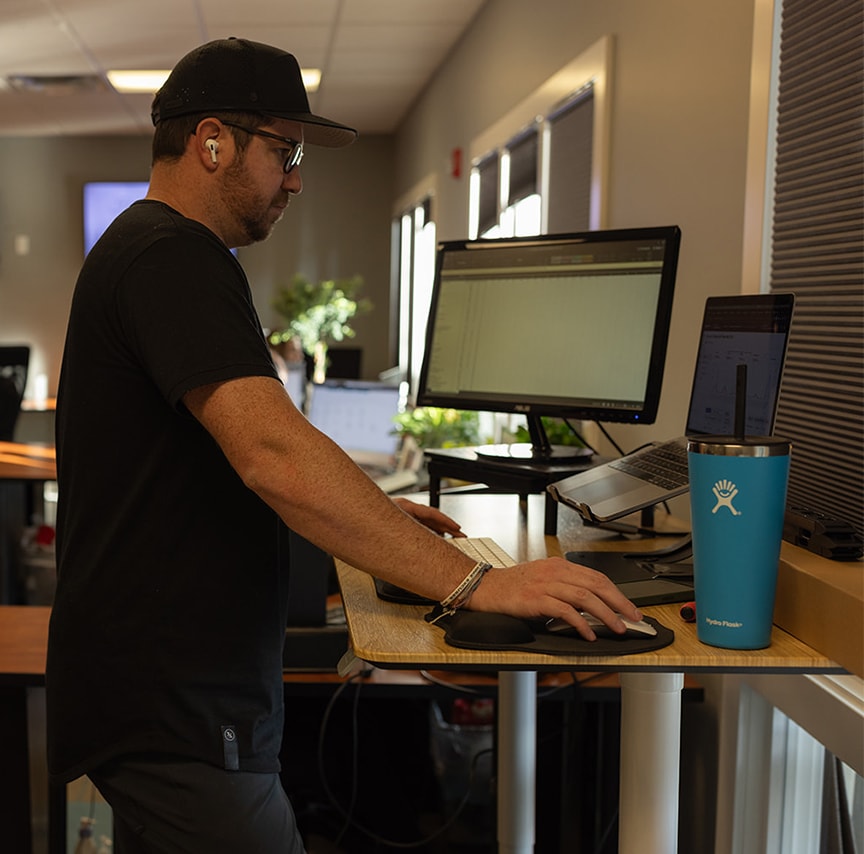 gentleman standing up working on computer